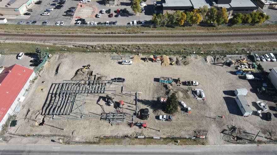 Aerial view of construction area for The Station. There is a steel structure being built.
