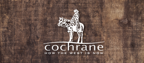 Town of Cochrane logo on a wood background