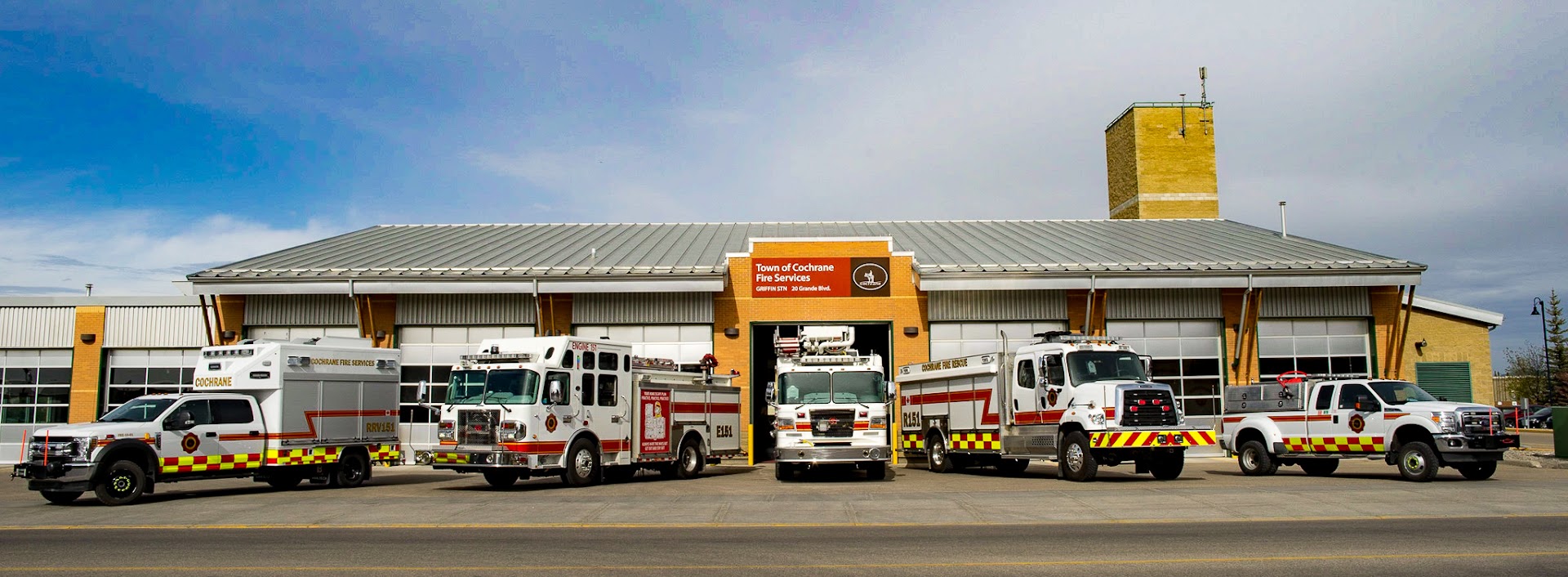 image of Cochrane 151 fire station with all fire vehicles parked out front
