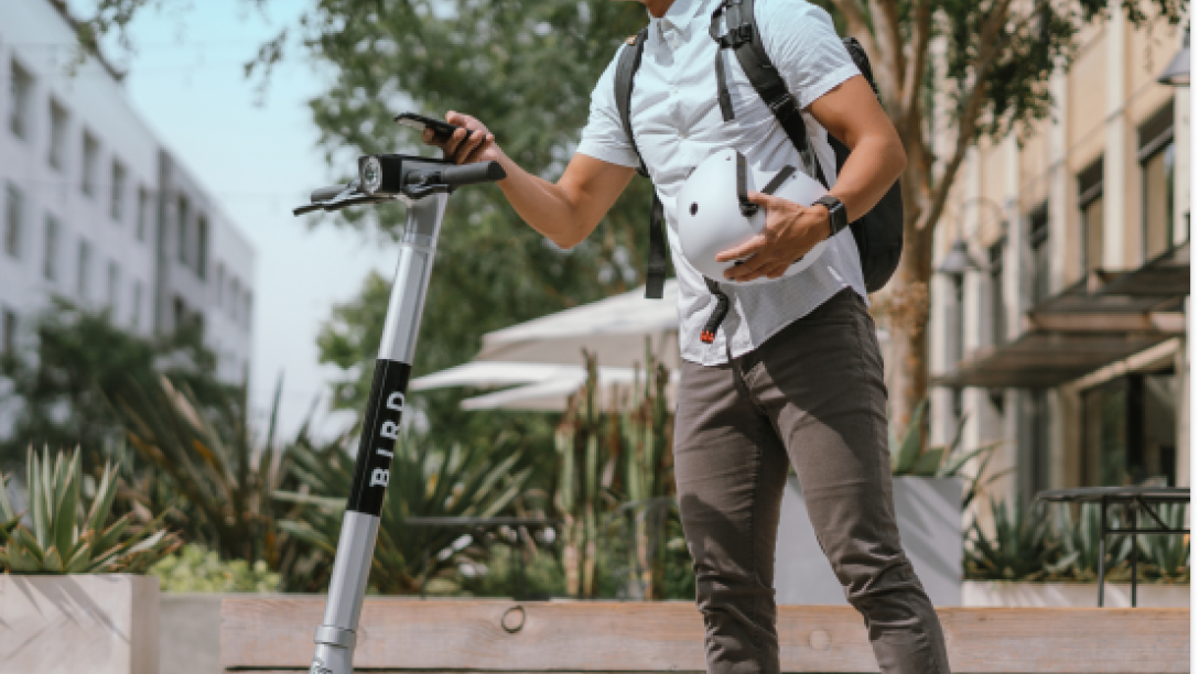 person riding bird e-scooter