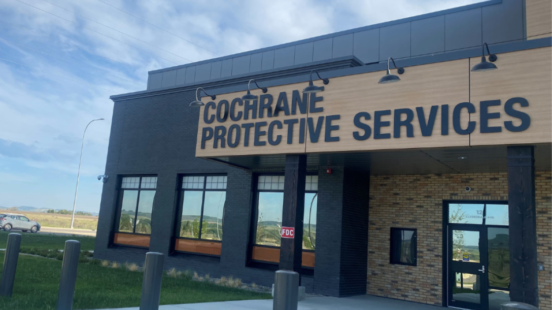 Cochrane protective services front of brown and black building