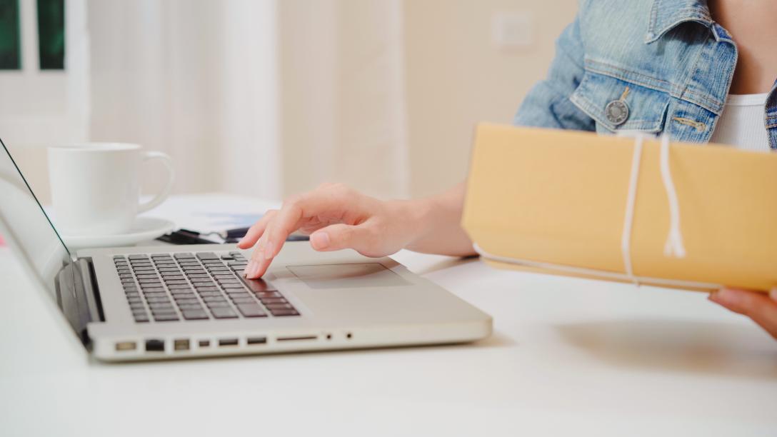 hand on laptop computer typing