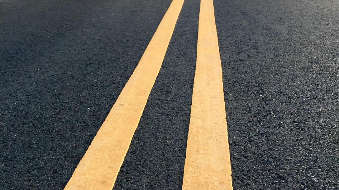 low-angle-view-of-an-open-winding-road-through-a-p-2024-10-18-07-14-12-utc.jpg