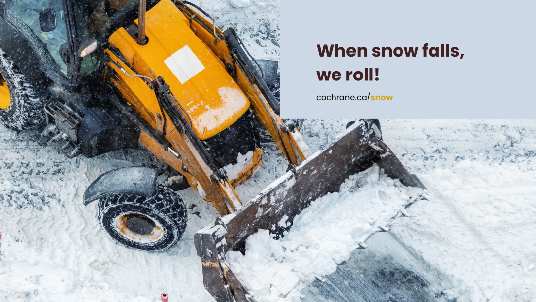 A yellow snowplow tractor clears snow from the road