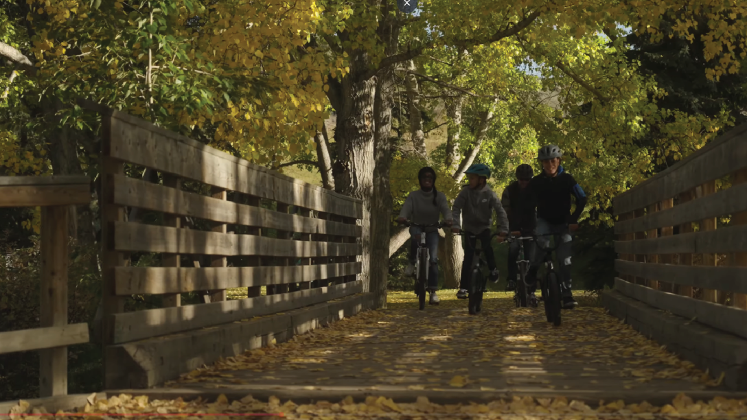 Family riding bikes in the Ranche in the fall