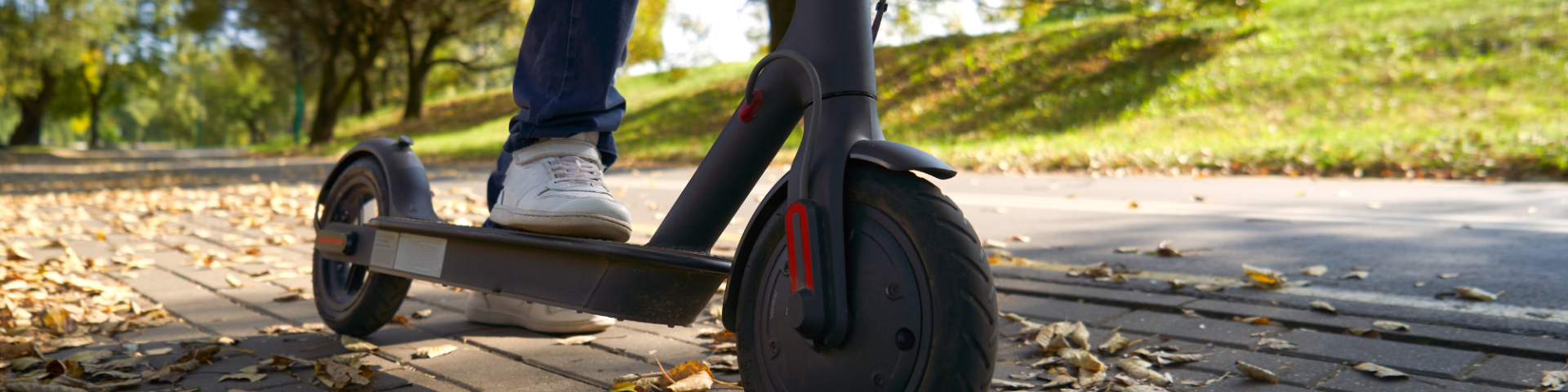 person riding electric scooter on pathway