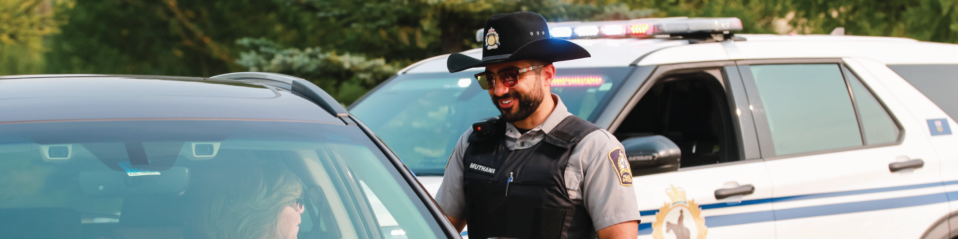 Municipal enforcement officer with residents in a car