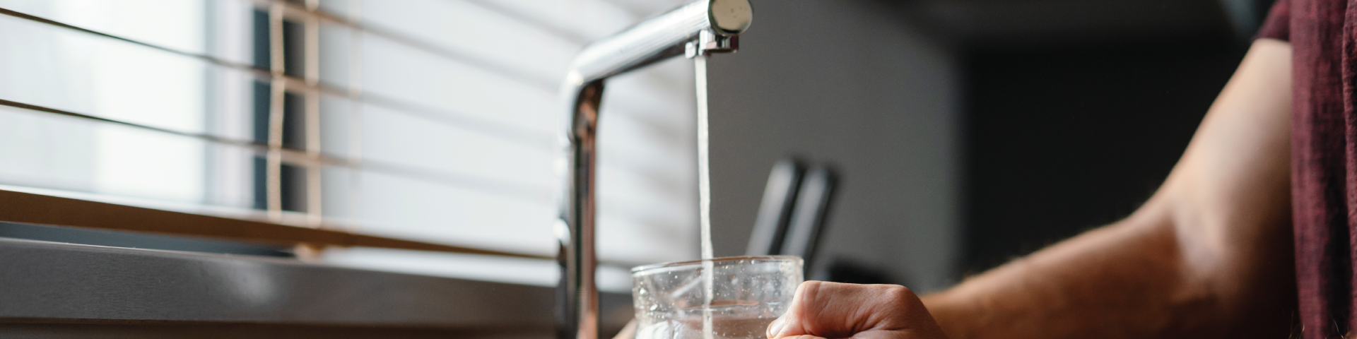 Household tap filling cup with water