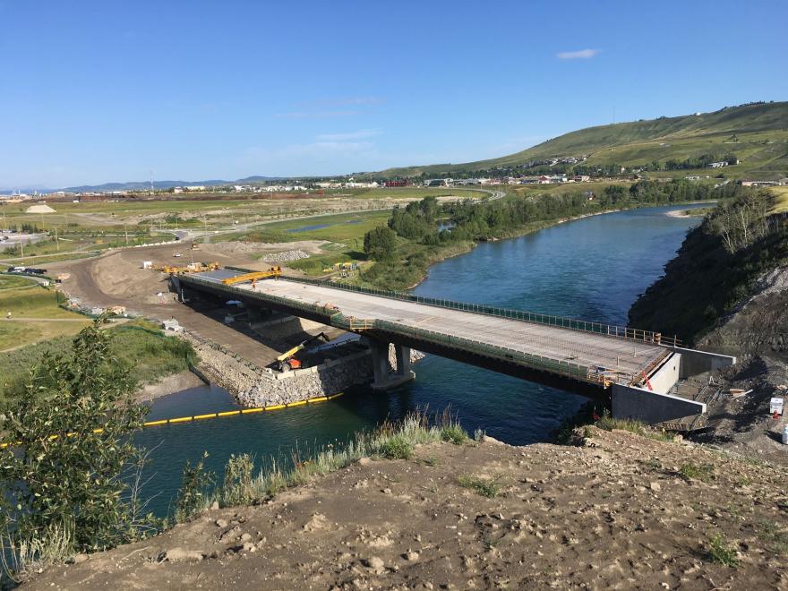 Side view of bridge under construction. Most of the bridge is constructed.