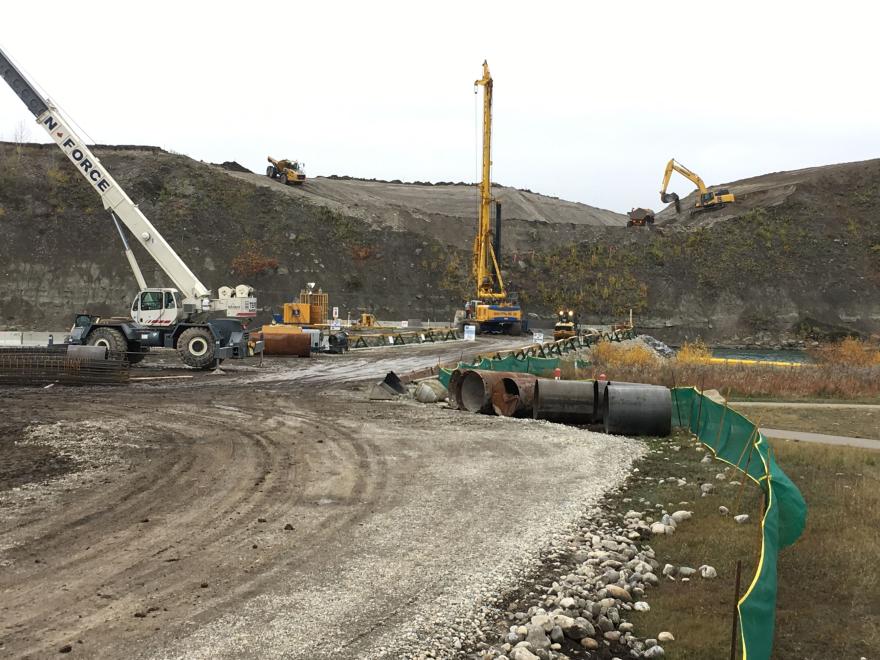 Cranes and heavy construction machinery working at bridge site.