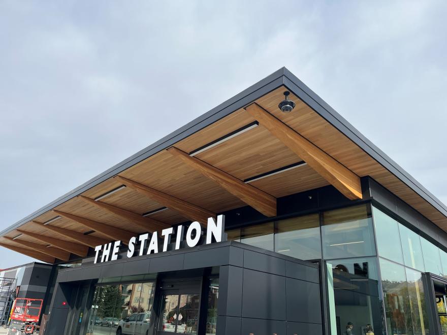 Exterior of The Station building. The Station is a small, square wood and glass building.