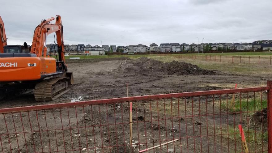 Construction site for Protective Services Building. There is heavy construction machinery clearing out the terrain.