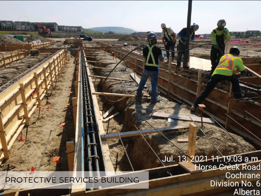 Construction workers preparing the foundation for the new Protective Services Building.