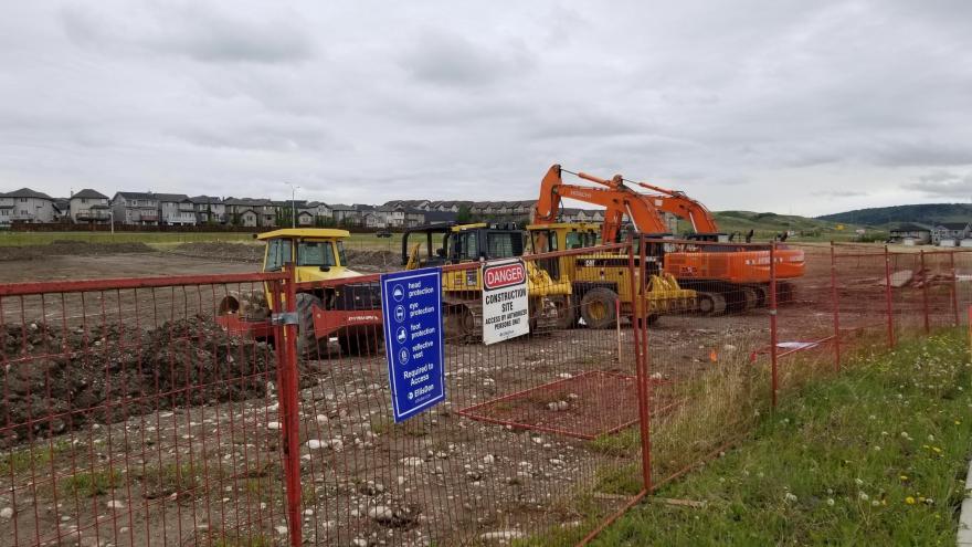 Construction site for Protective Services Building. There is heavy construction machinery clearing out the terrain.