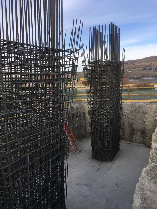 Rebar pillars inside of construction dig site.