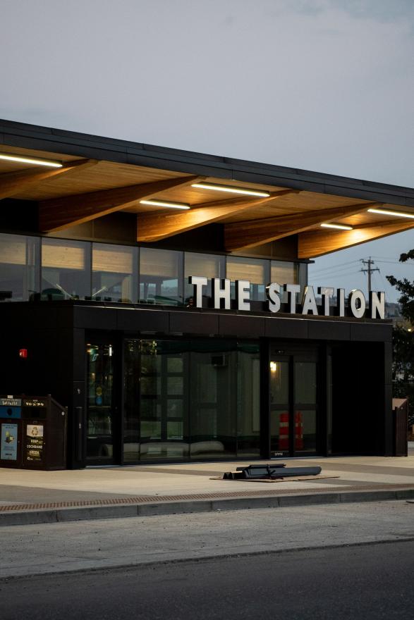 Exterior of The Sation building at dusk. The building has signing with its name over the entrance.