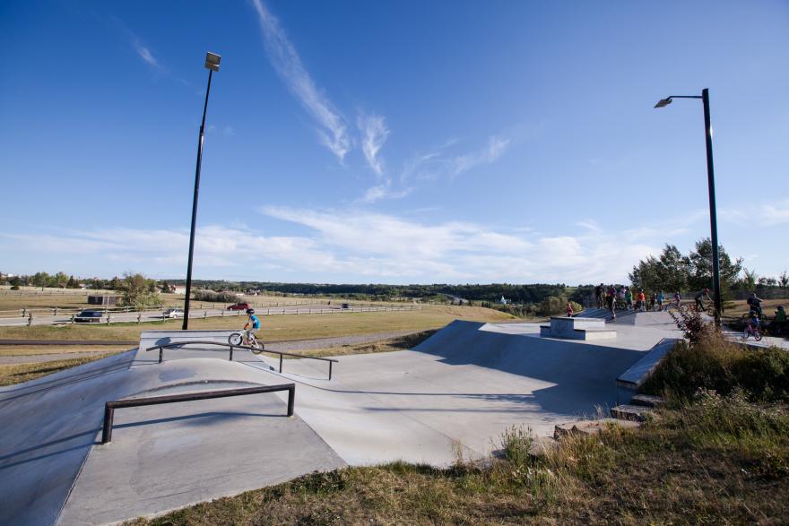 Kid riding bike through a skate park 