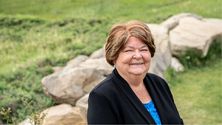 Councillor Flowers smiling at camera with green background