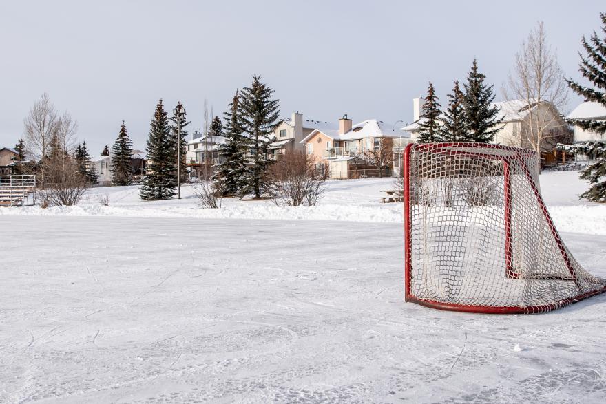 frozen over pond with hockey net 