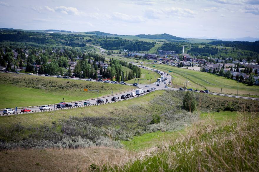 Cars on highway road travelling south on HWY 22 in Cochrane, AB.