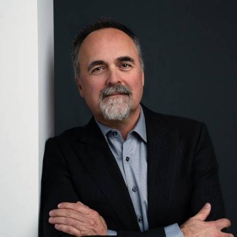 David Cooper leaning against a wall