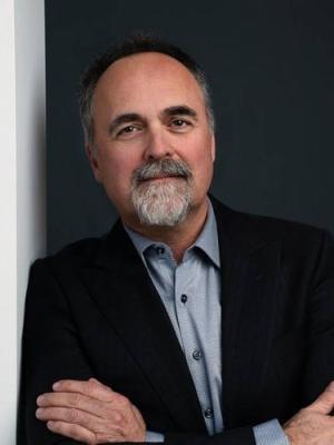 David Cooper leaning against a wall